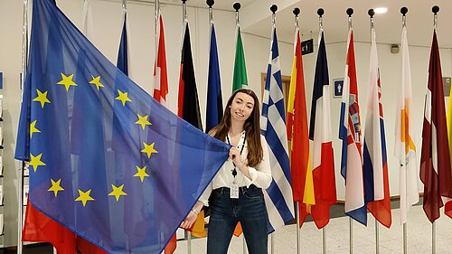 Chelsea Whyte with the flags of the EU