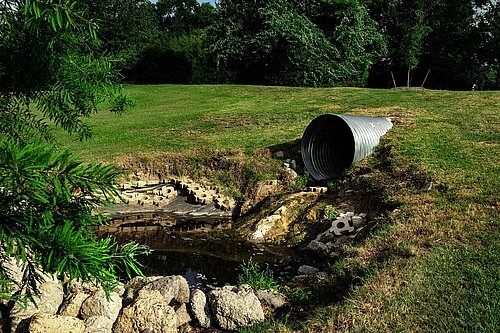 Sewage pipe close to a waterway